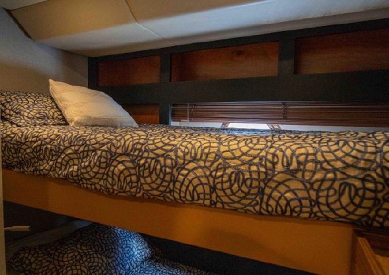 a bed with a patterned comforter aboard 2016 AZIMUT MAGELLANO 66 Yacht for Sale