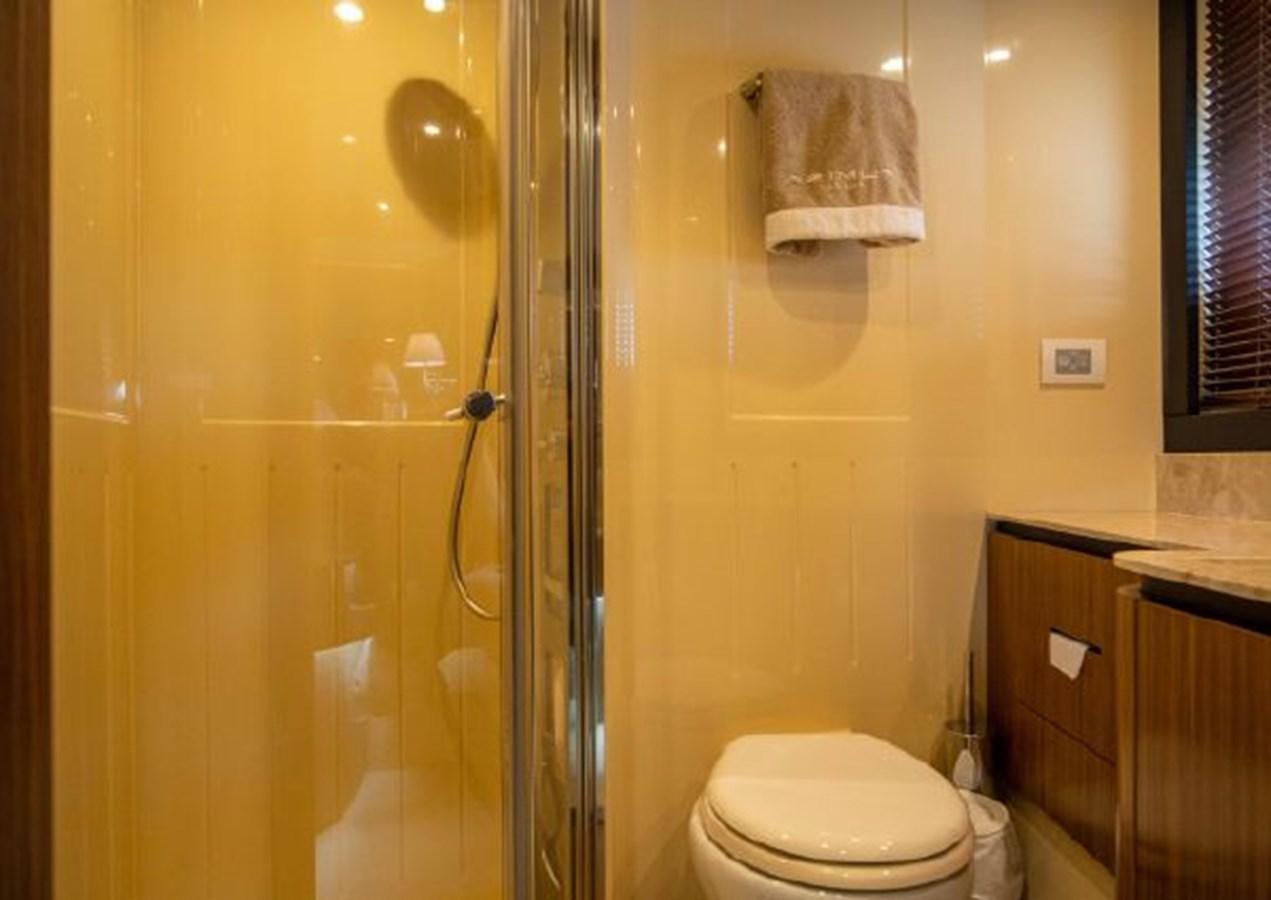 a bathroom with a glass shower door aboard 2016 AZIMUT MAGELLANO 66 Yacht for Sale