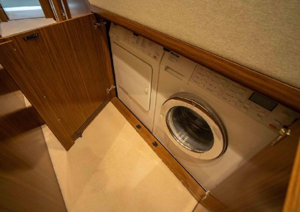 a washing machine in a room aboard 2016 AZIMUT MAGELLANO 66 Yacht for Sale