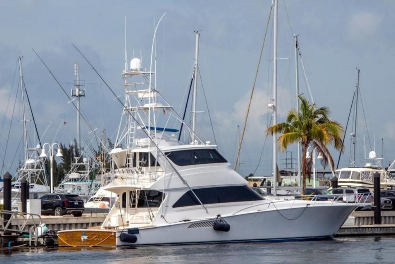 a white boat in a harbor aboard ENCLOSED BRIDGE Yacht for Sale