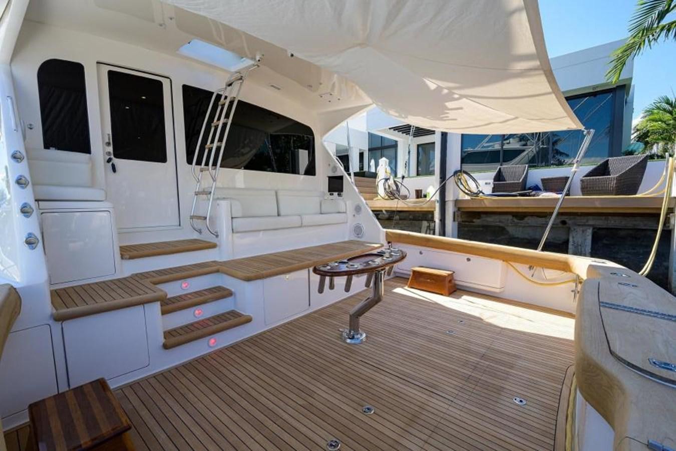 a room with a table and chairs aboard ENCLOSED BRIDGE Yacht for Sale