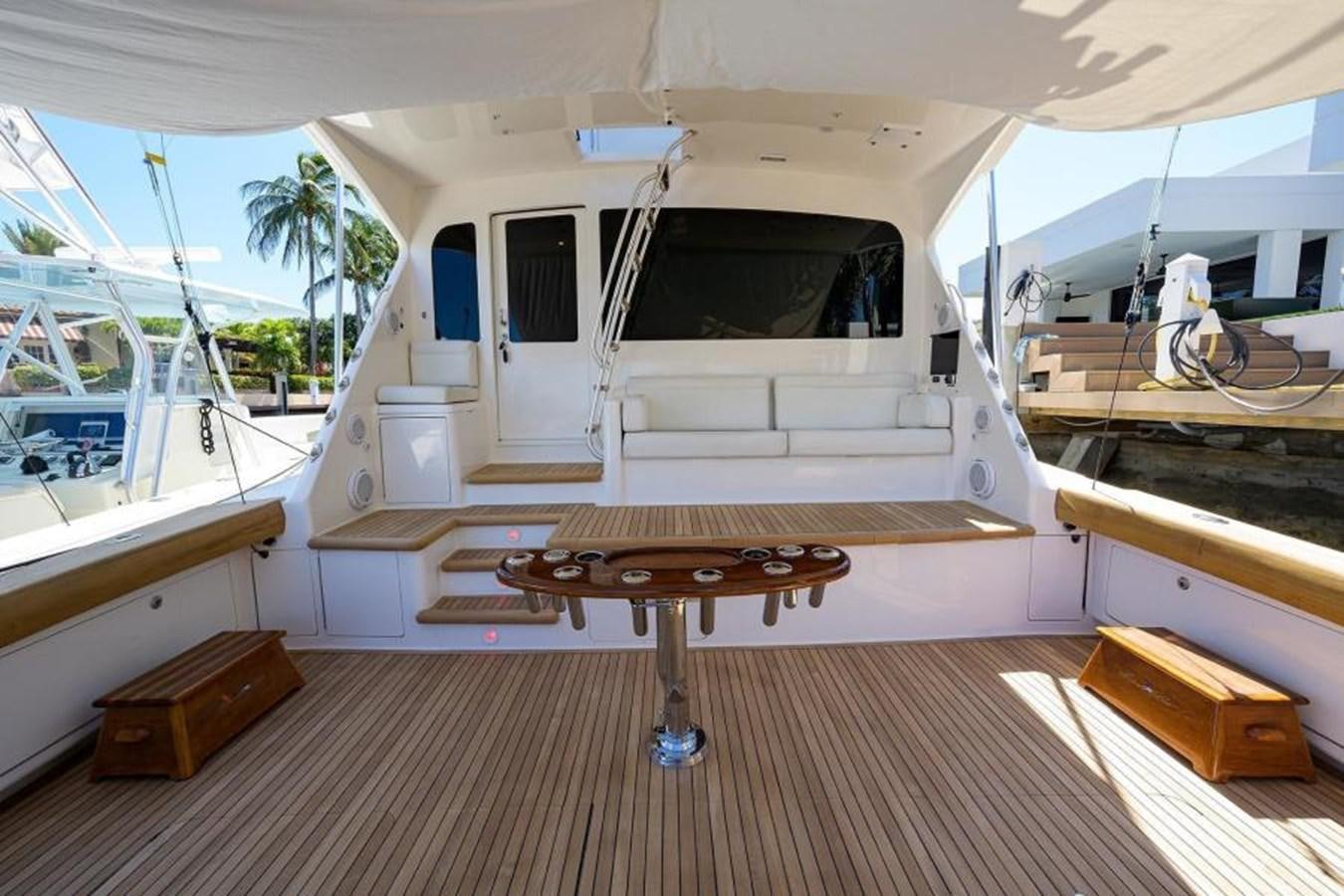 a large white boat with a bench aboard ENCLOSED BRIDGE Yacht for Sale