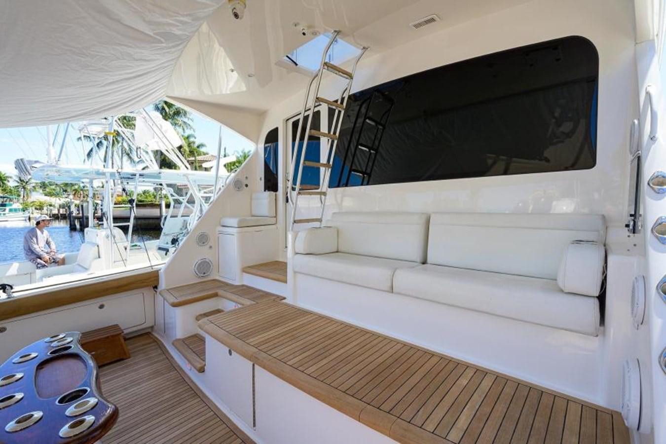 a boat with a person sitting on it aboard ENCLOSED BRIDGE Yacht for Sale