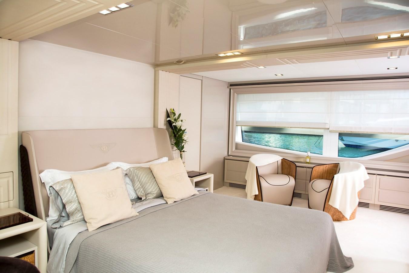 a bed with a white bed spread aboard SONNY II Yacht for Sale