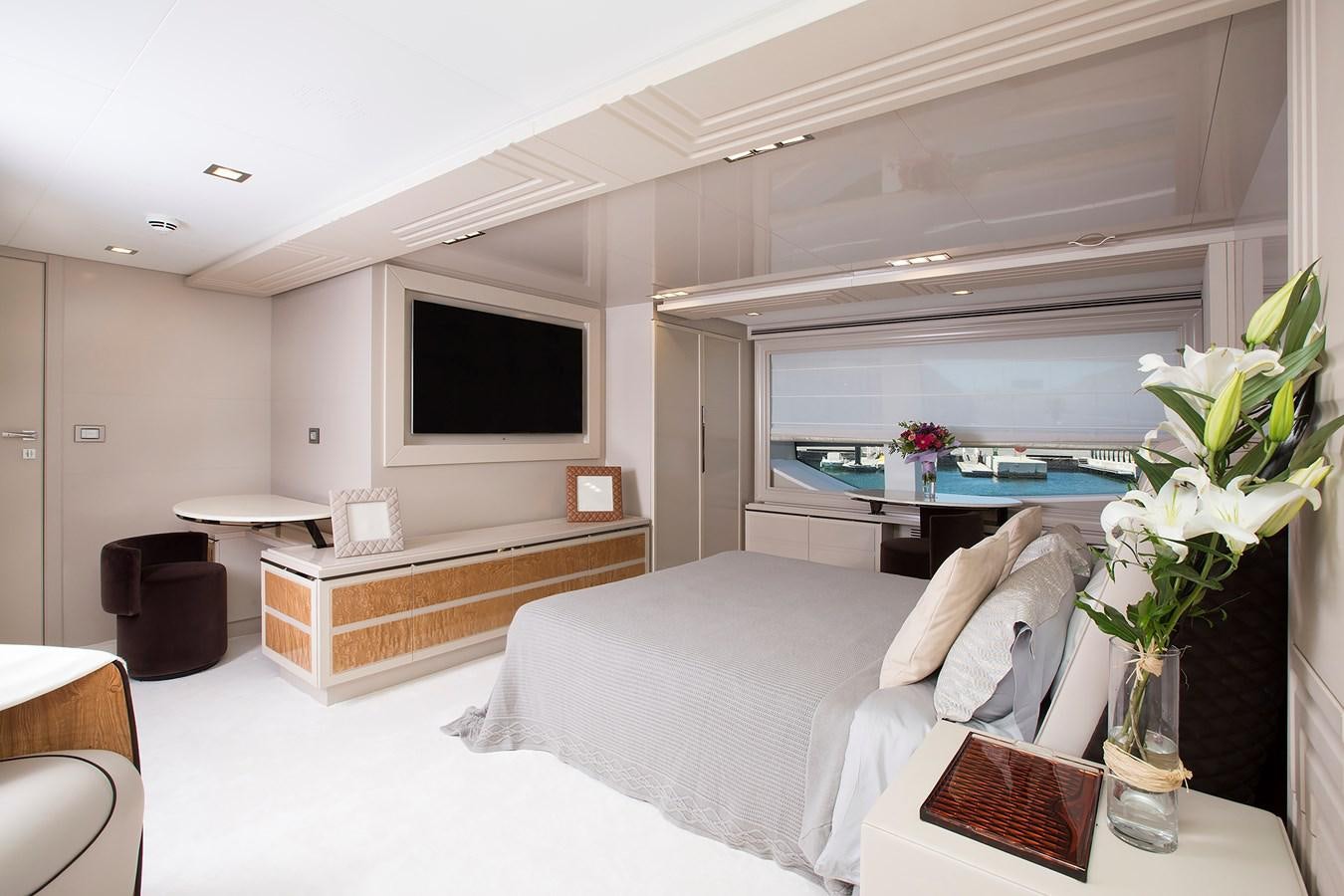 a bedroom with a bed and a tv aboard SONNY II Yacht for Sale