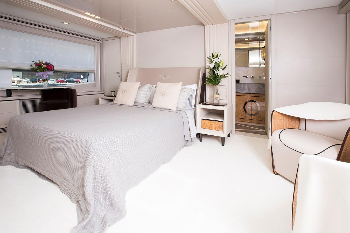 a bedroom with a bed and a fireplace aboard SONNY II Yacht for Sale