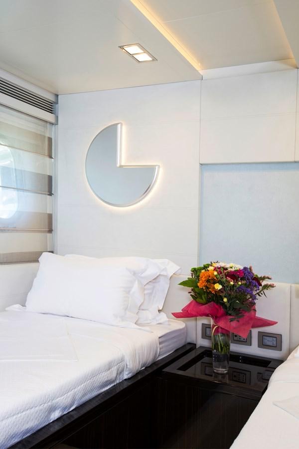 a room with a bed and a mirror aboard SONNY II Yacht for Sale