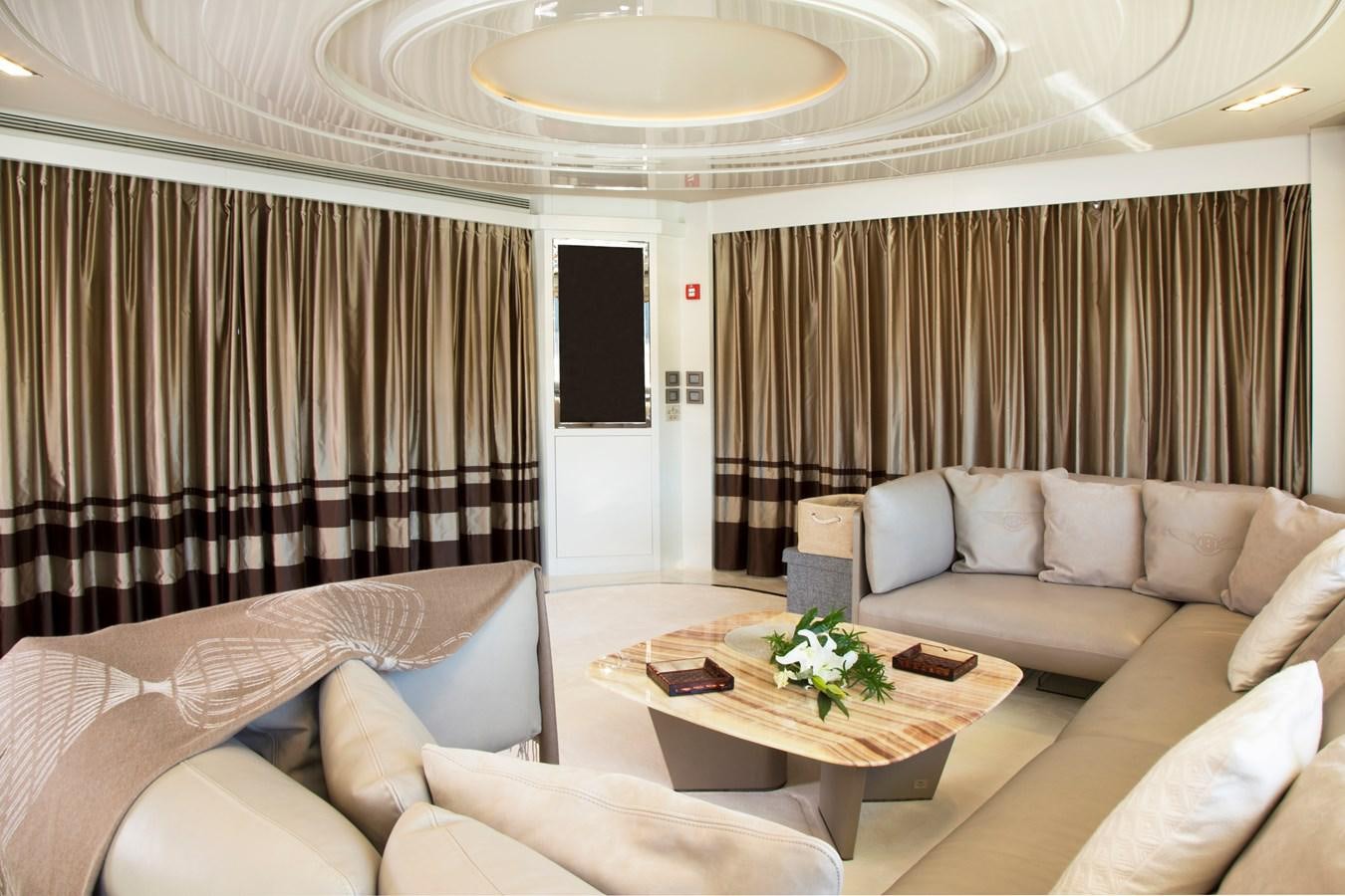 a living room with a couch and a table aboard SONNY II Yacht for Sale