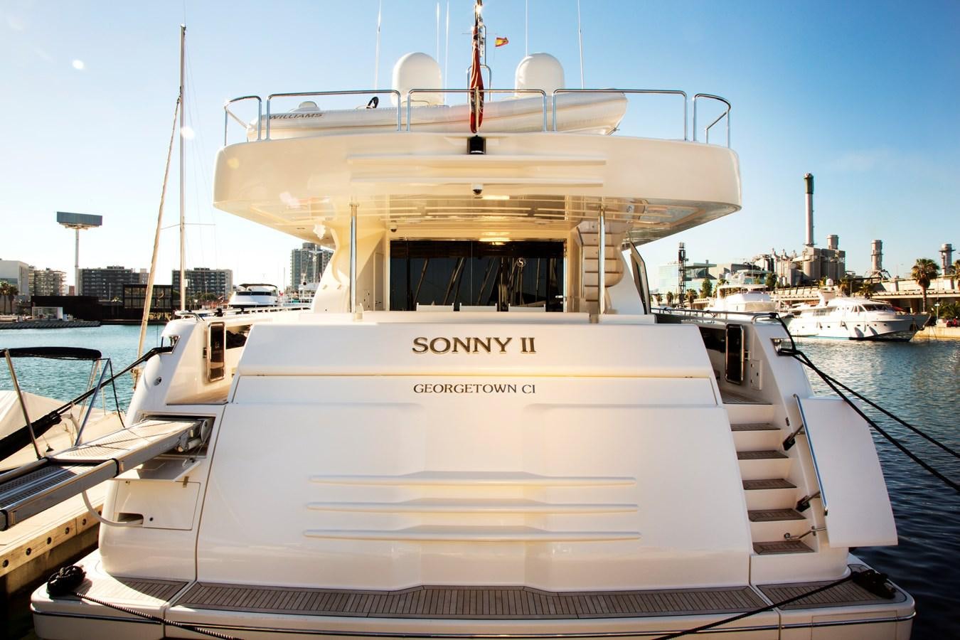a white boat in a harbor aboard SONNY II Yacht for Sale