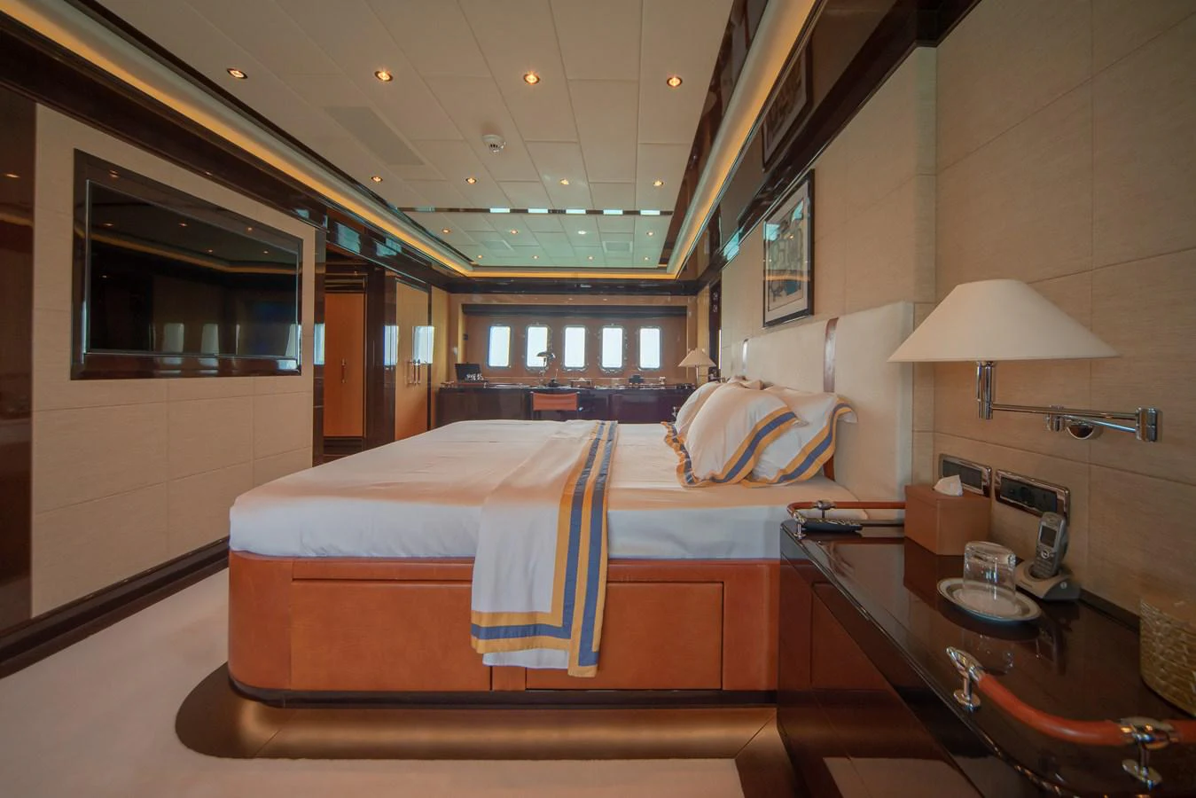 a bedroom with a bed and a table aboard SAMHAN Yacht for Sale