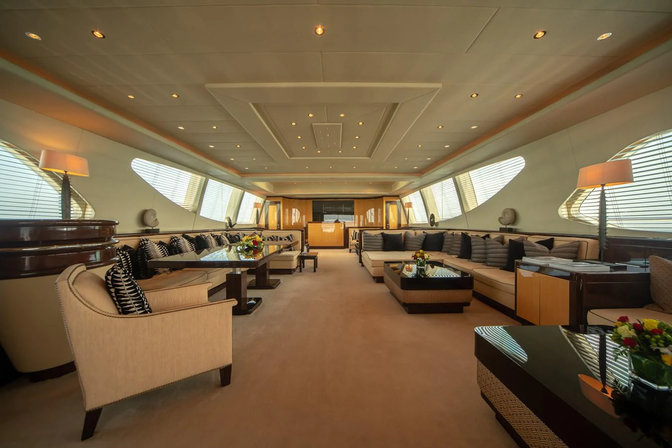 a living room with a large couch and a table aboard SAMHAN Yacht for Sale