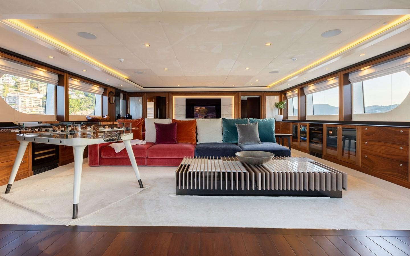 a large living room with a table and couches aboard MAXIMILIAN MMIV Yacht for Charter