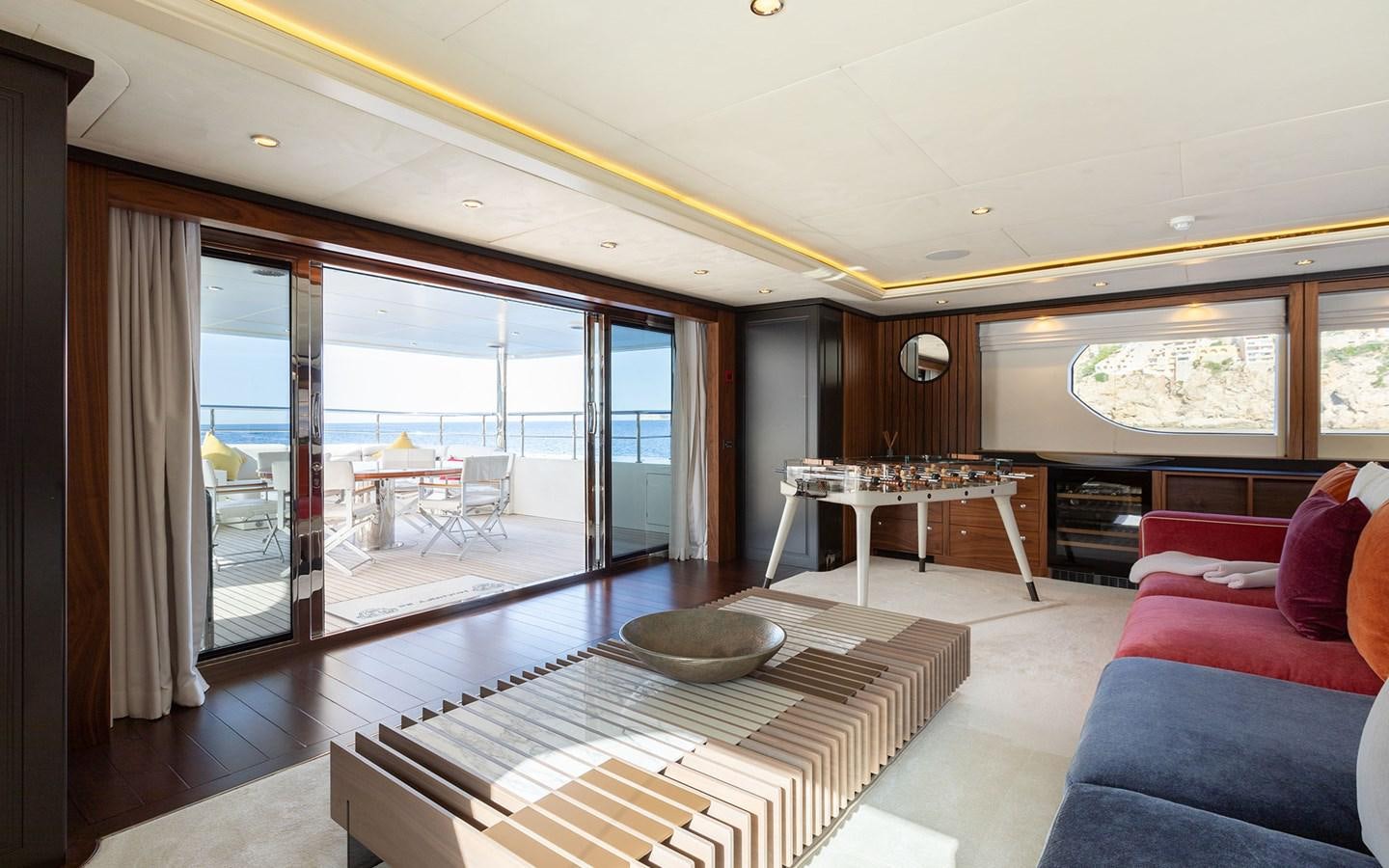 a living room with a large glass door aboard MAXIMILIAN MMIV Yacht for Charter