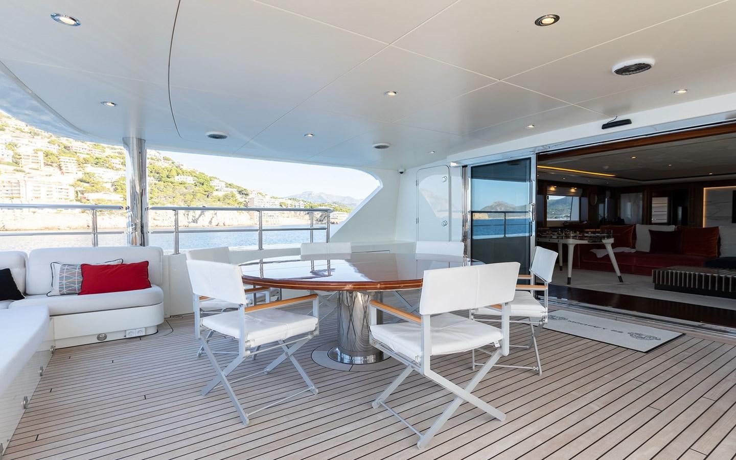 a room with a table chairs and a couch aboard MAXIMILIAN MMIV Yacht for Charter