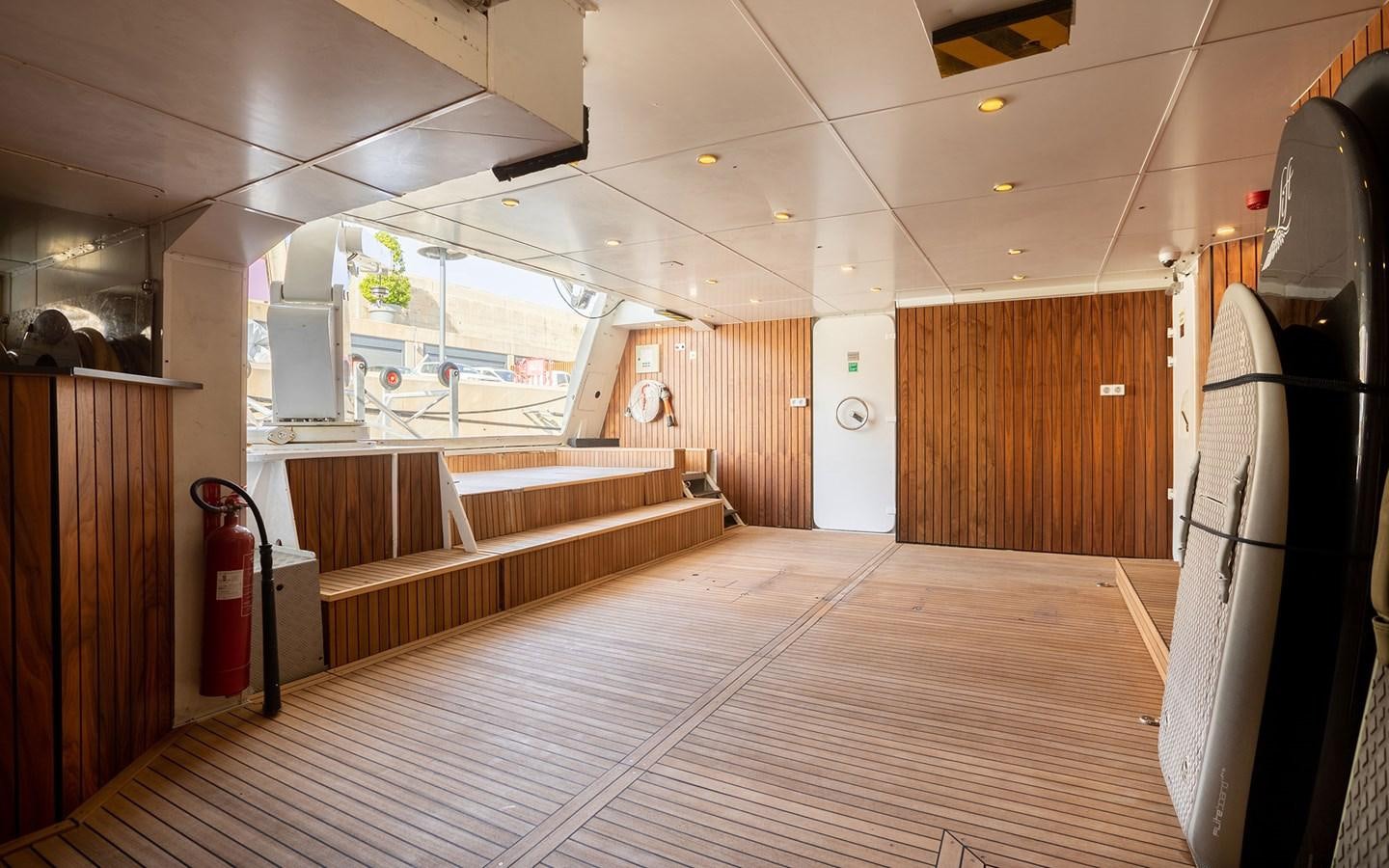 a room with wooden furniture aboard MAXIMILIAN MMIV Yacht for Charter