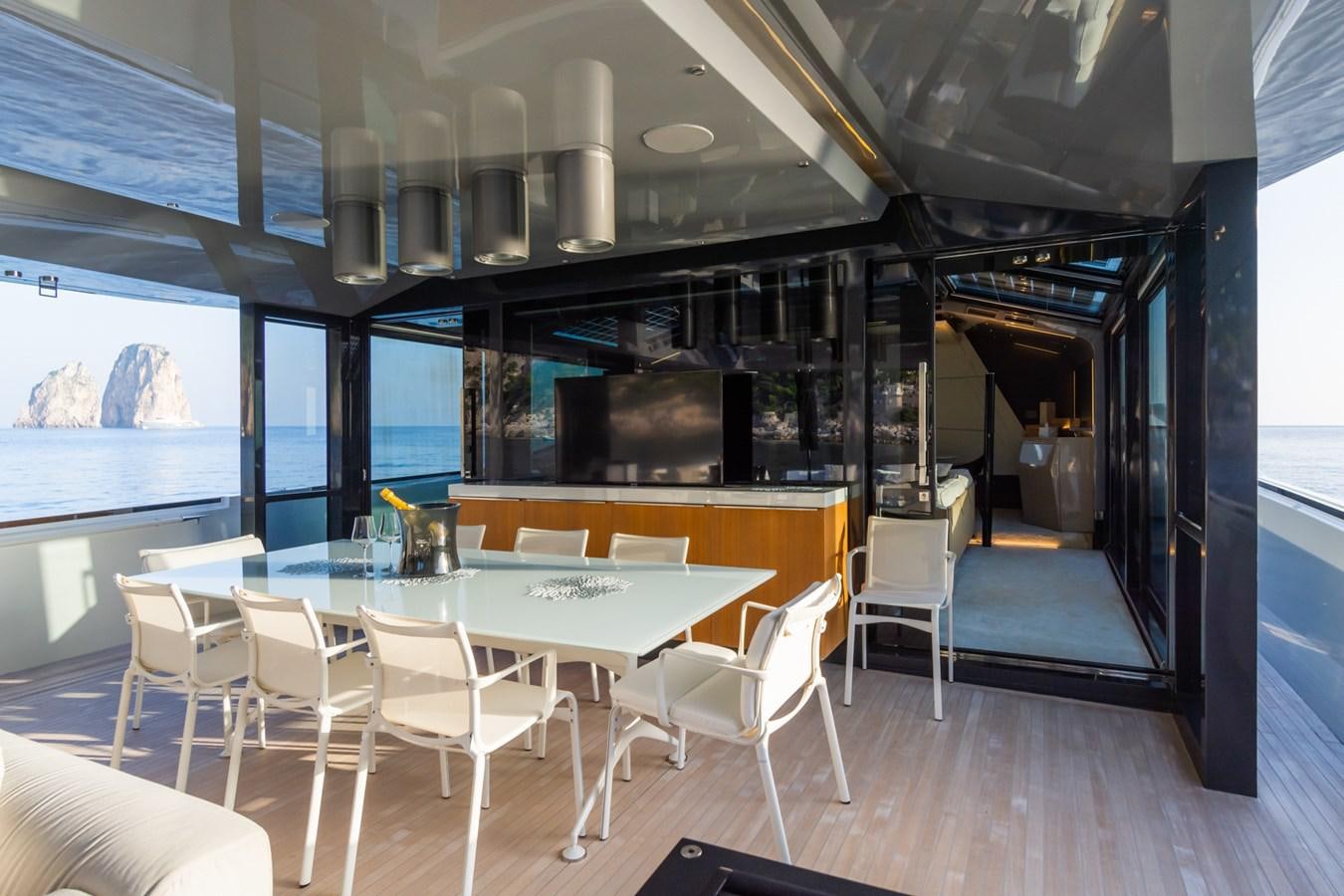 a room with tables and chairs aboard MILU' Yacht for Sale