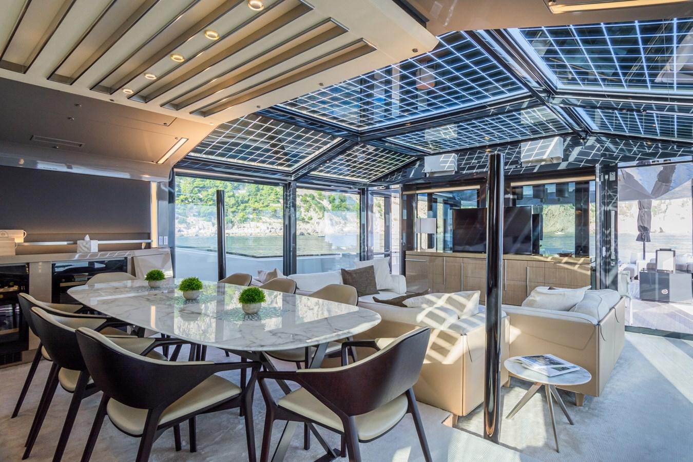 a room with tables and chairs aboard MILU' Yacht for Sale