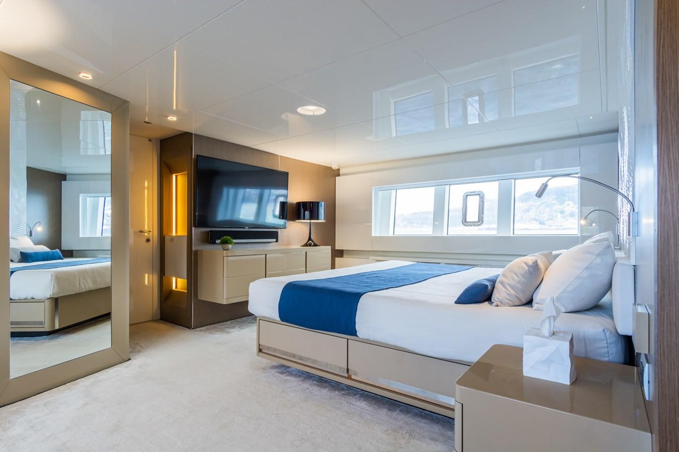 a bedroom with a bed and a tv aboard MILU' Yacht for Sale