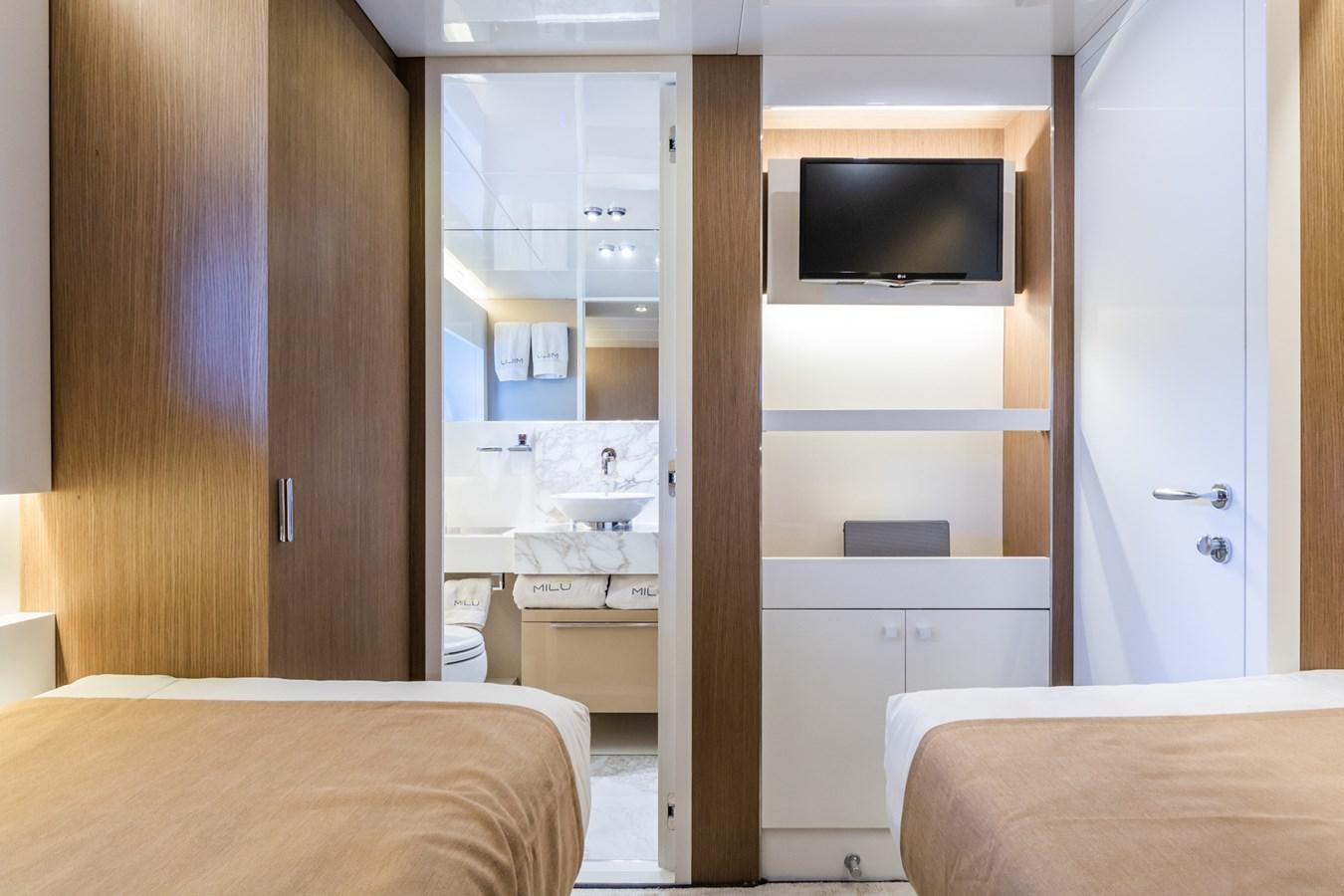 a bedroom with a bed and a television aboard MILU' Yacht for Sale