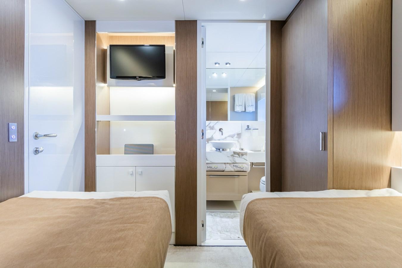 a bedroom with a bed and a television aboard MILU' Yacht for Sale