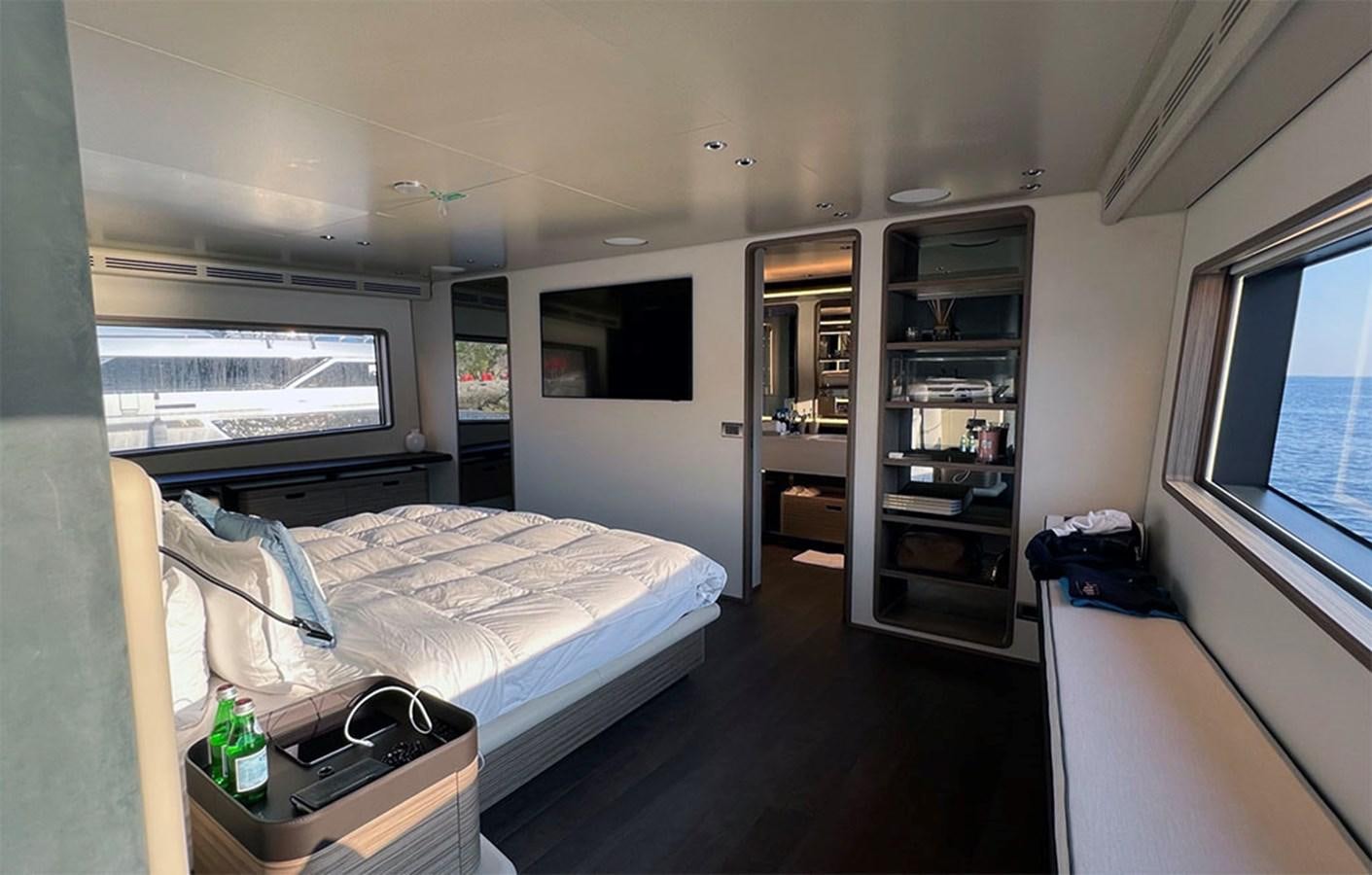 a room with a bed and a shelf with a bookcase aboard CHECKMATE Yacht for Sale