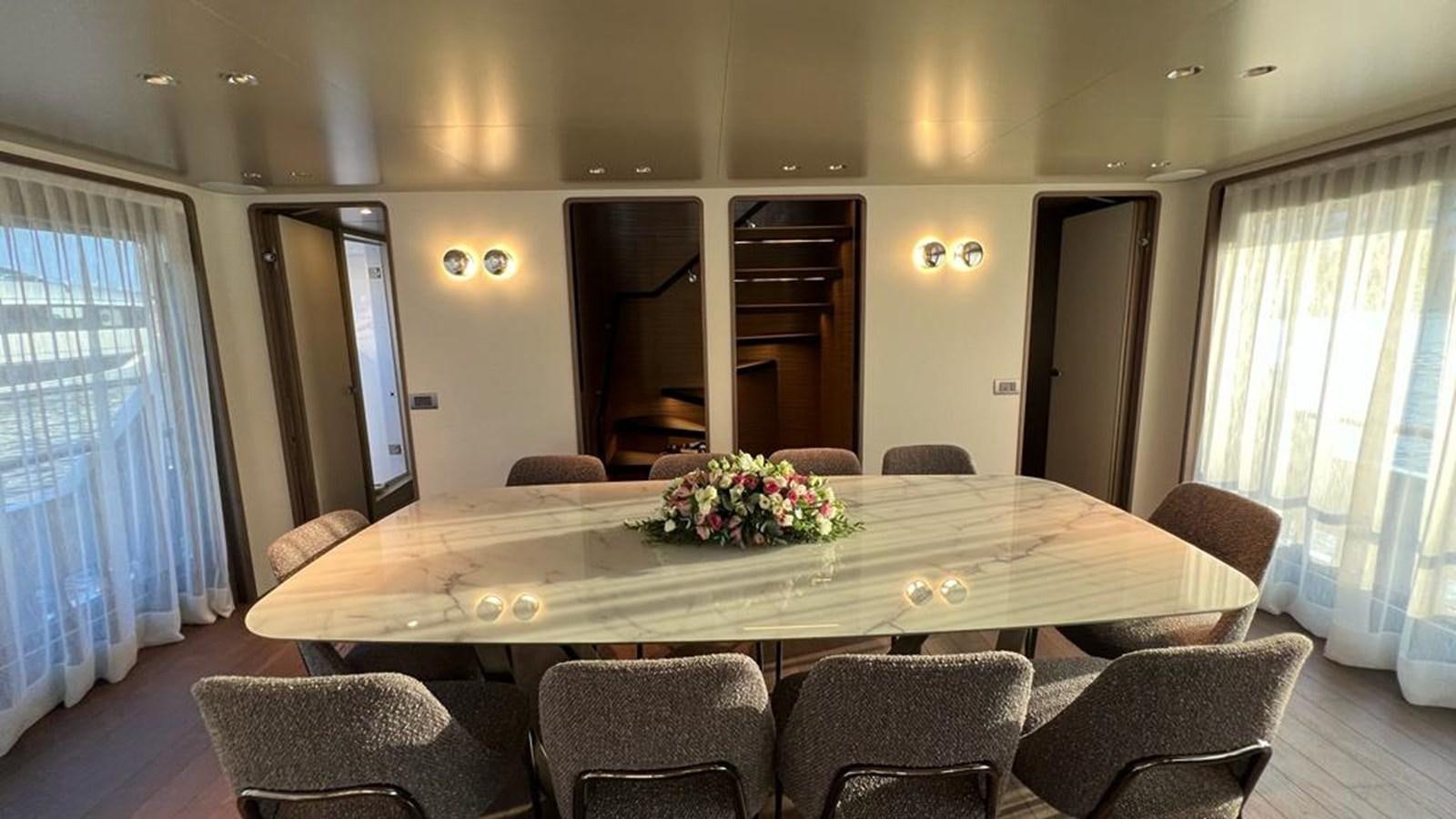 a large conference room with a table and chairs aboard CHECKMATE Yacht for Sale