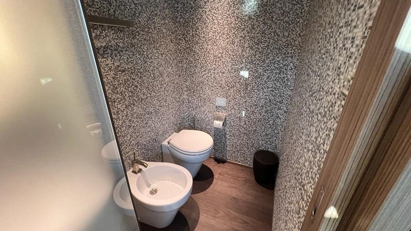 a bathroom with a toilet and a sink aboard CHECKMATE Yacht for Sale
