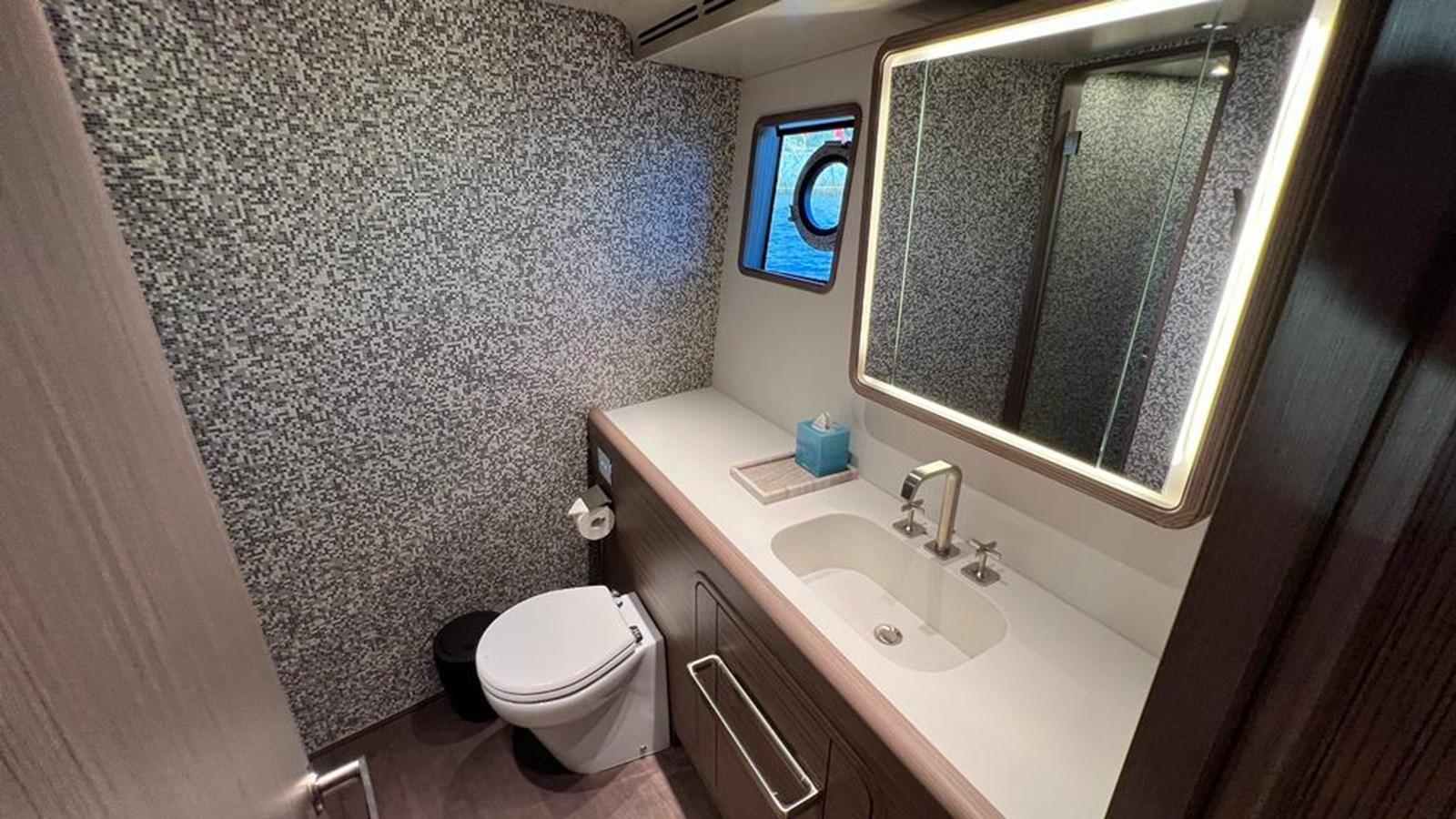 a bathroom with a toilet and a sink aboard CHECKMATE Yacht for Sale