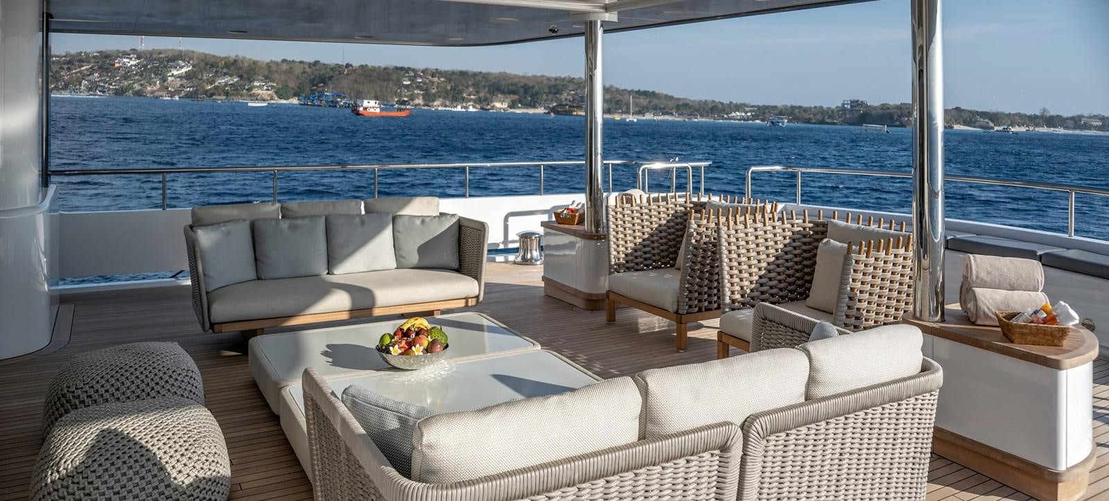 a room with a table chairs and a large body of water aboard ATLAS Yacht for Sale