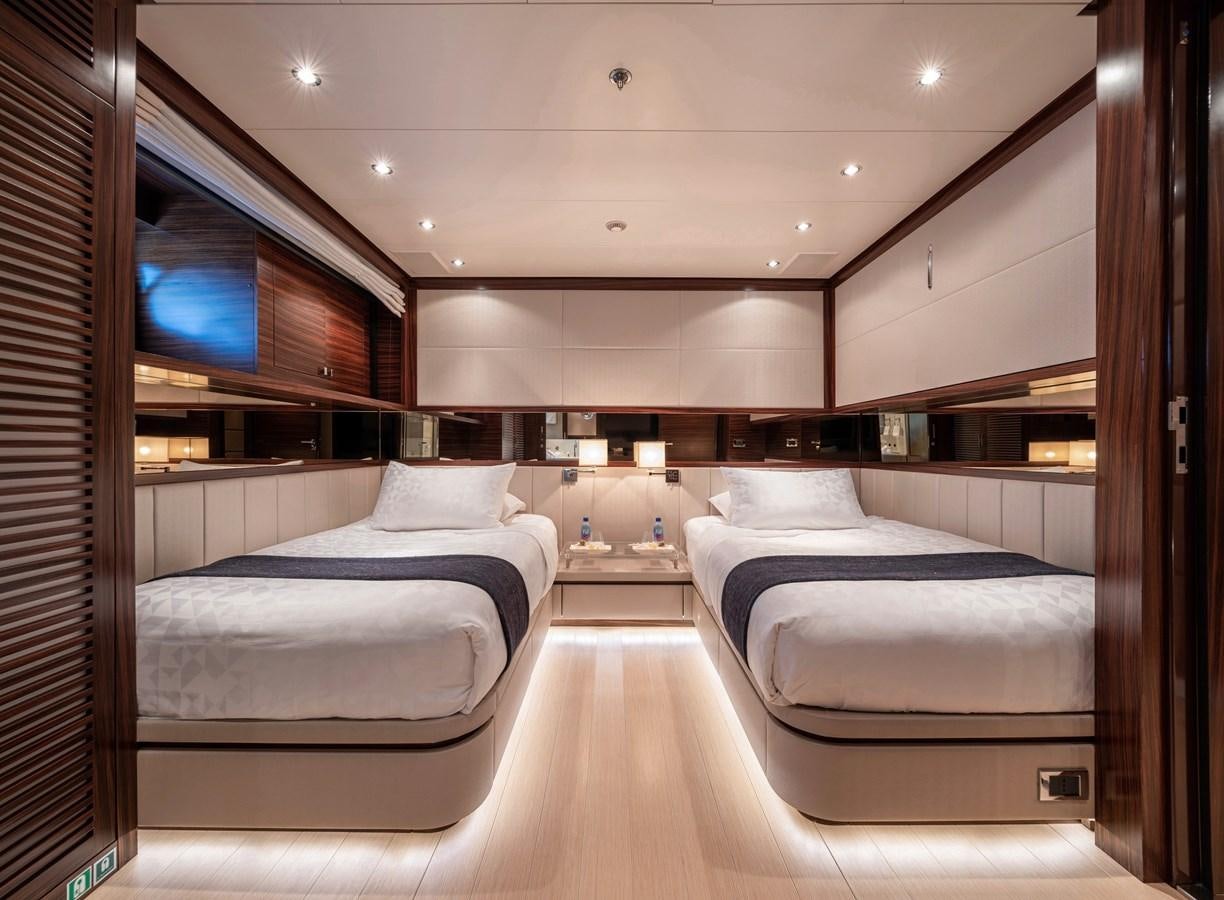 a room with beds and a tv aboard ATLAS Yacht for Sale