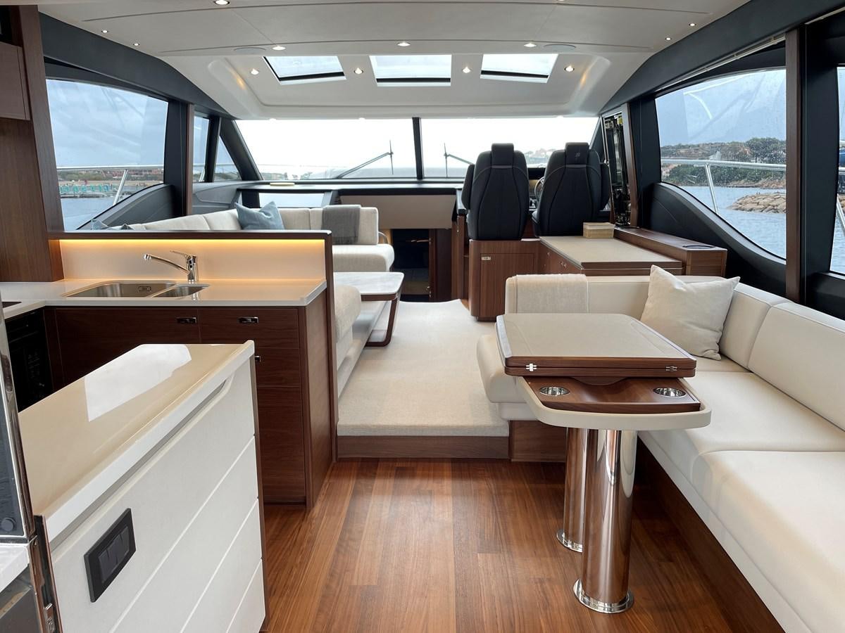 a room with a table and chairs aboard LESTO Yacht for Sale