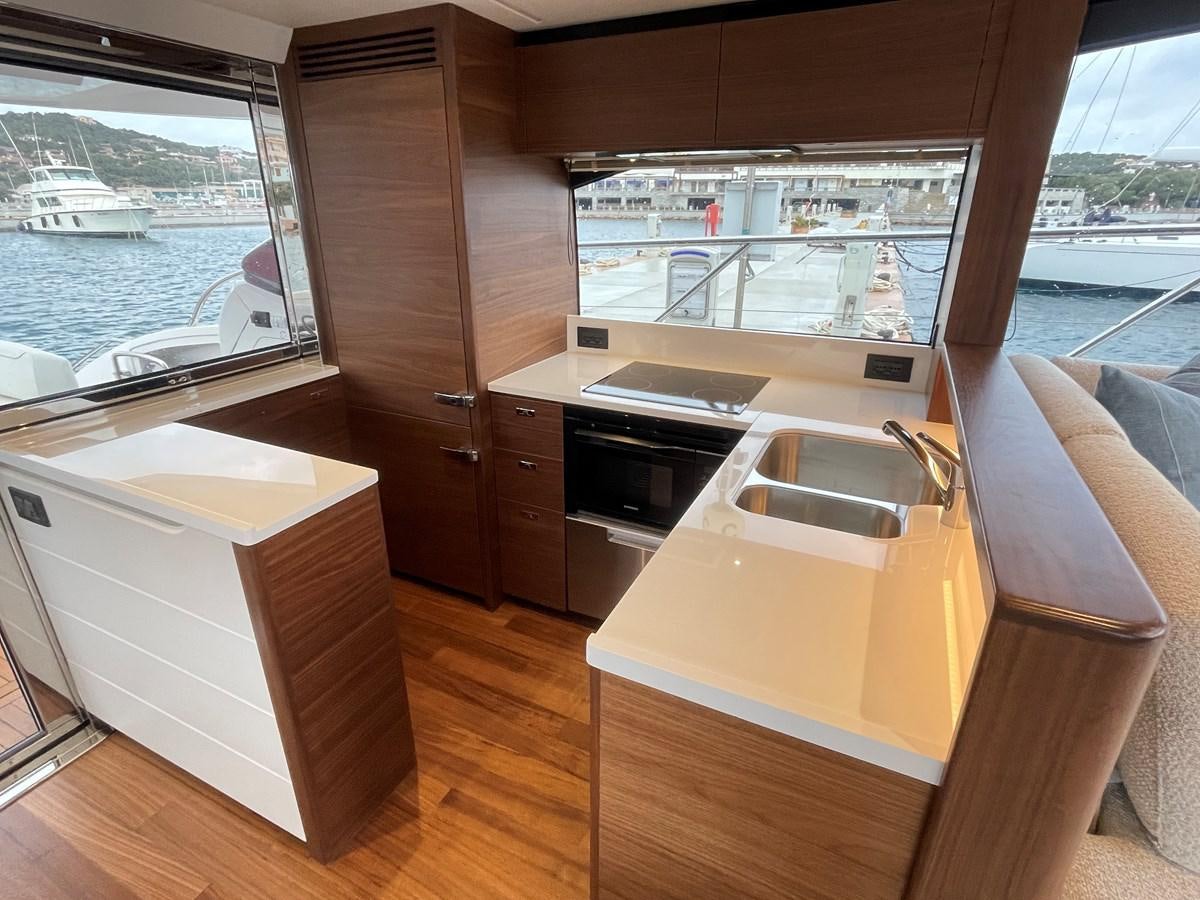 a kitchen with a large window aboard LESTO Yacht for Sale