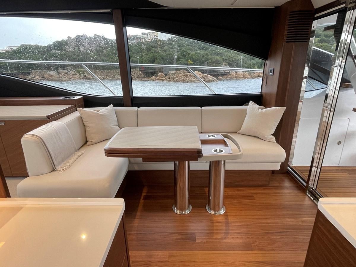 a room with a couch and a table and a window aboard LESTO Yacht for Sale