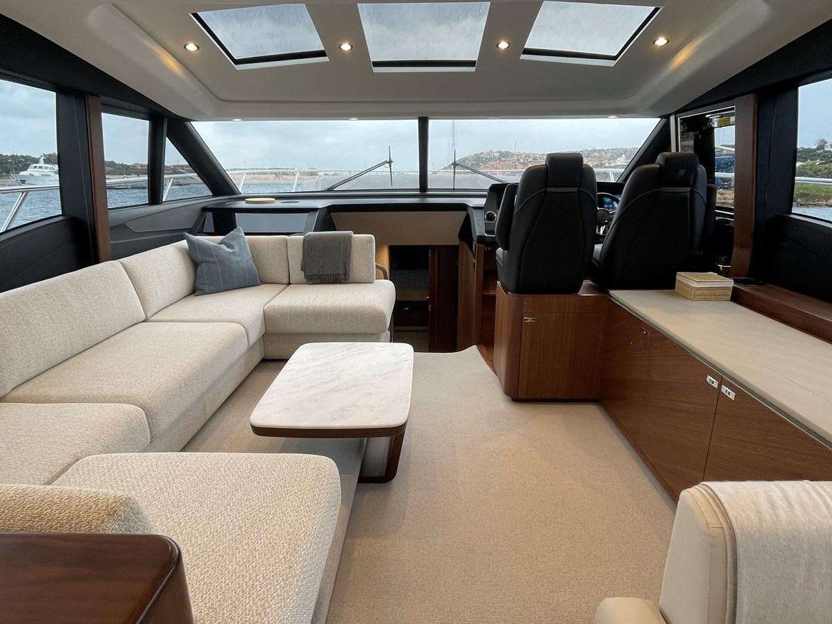 inside of a vehicle with seats and tables and chairs aboard LESTO Yacht for Sale