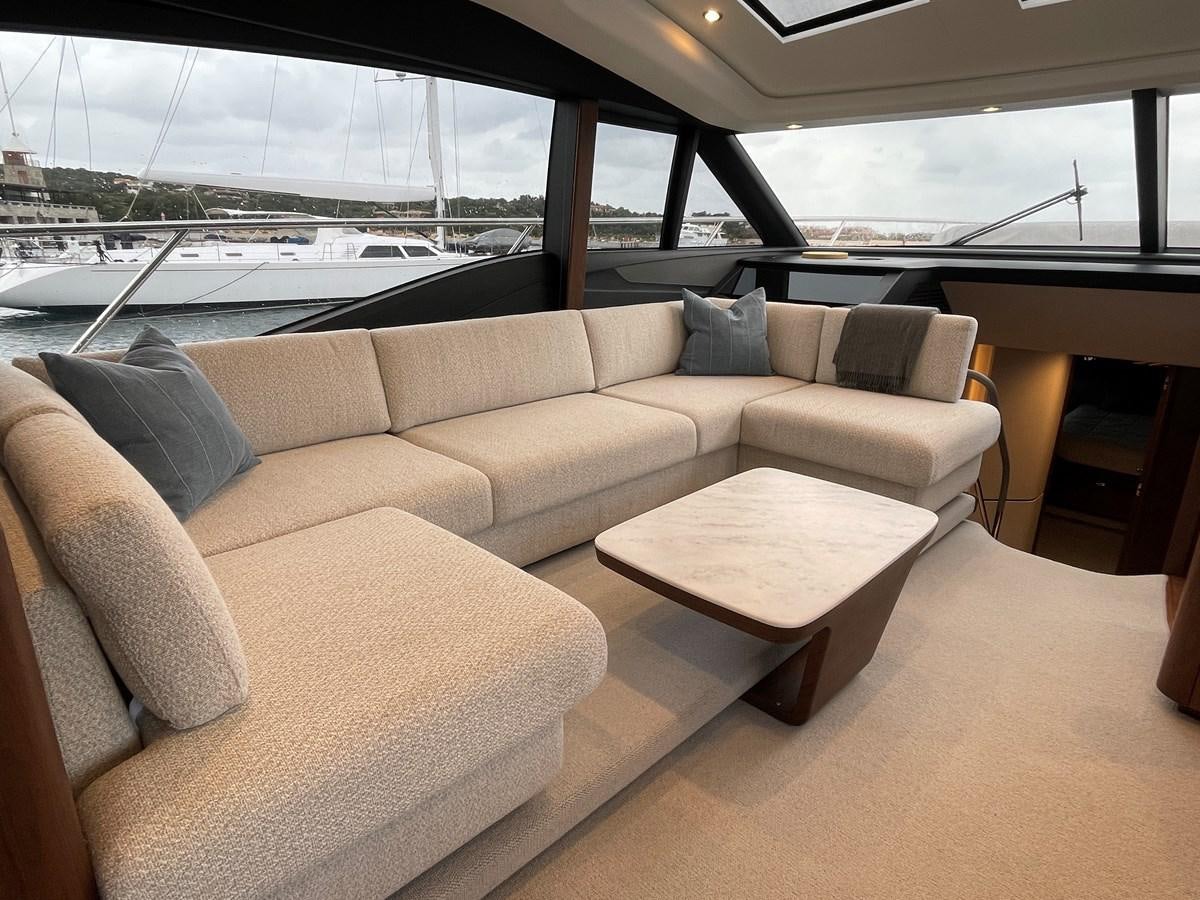 a couch and a table in a room with a window aboard LESTO Yacht for Sale
