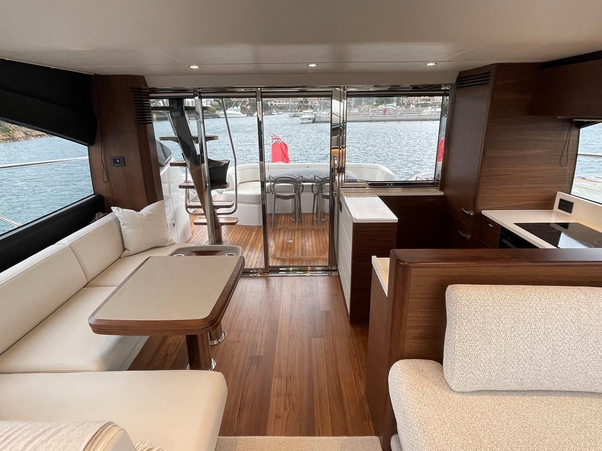 a room with a table chairs and a large window aboard LESTO Yacht for Sale