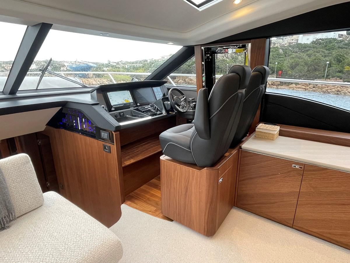 a car with a desk and a chair aboard LESTO Yacht for Sale