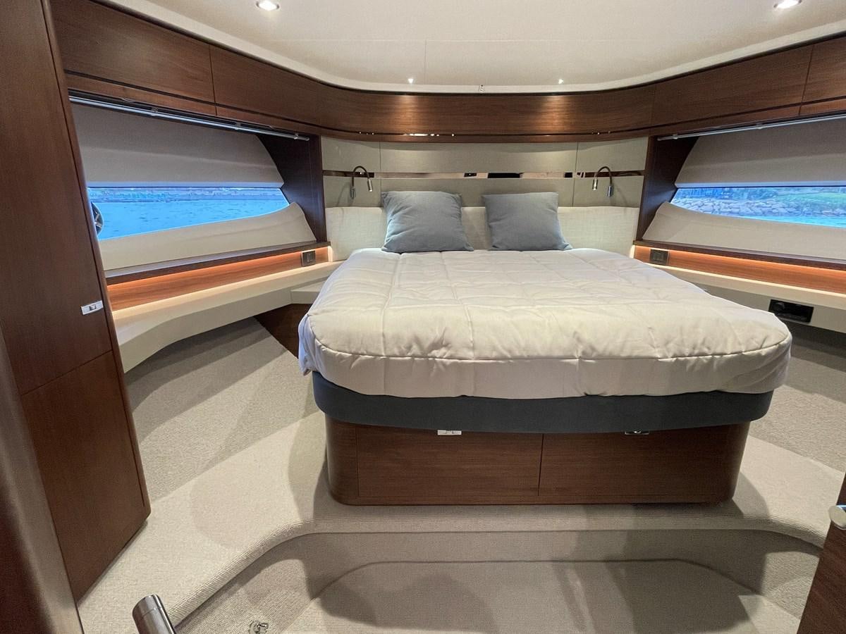 a room with a bed and a window aboard LESTO Yacht for Sale