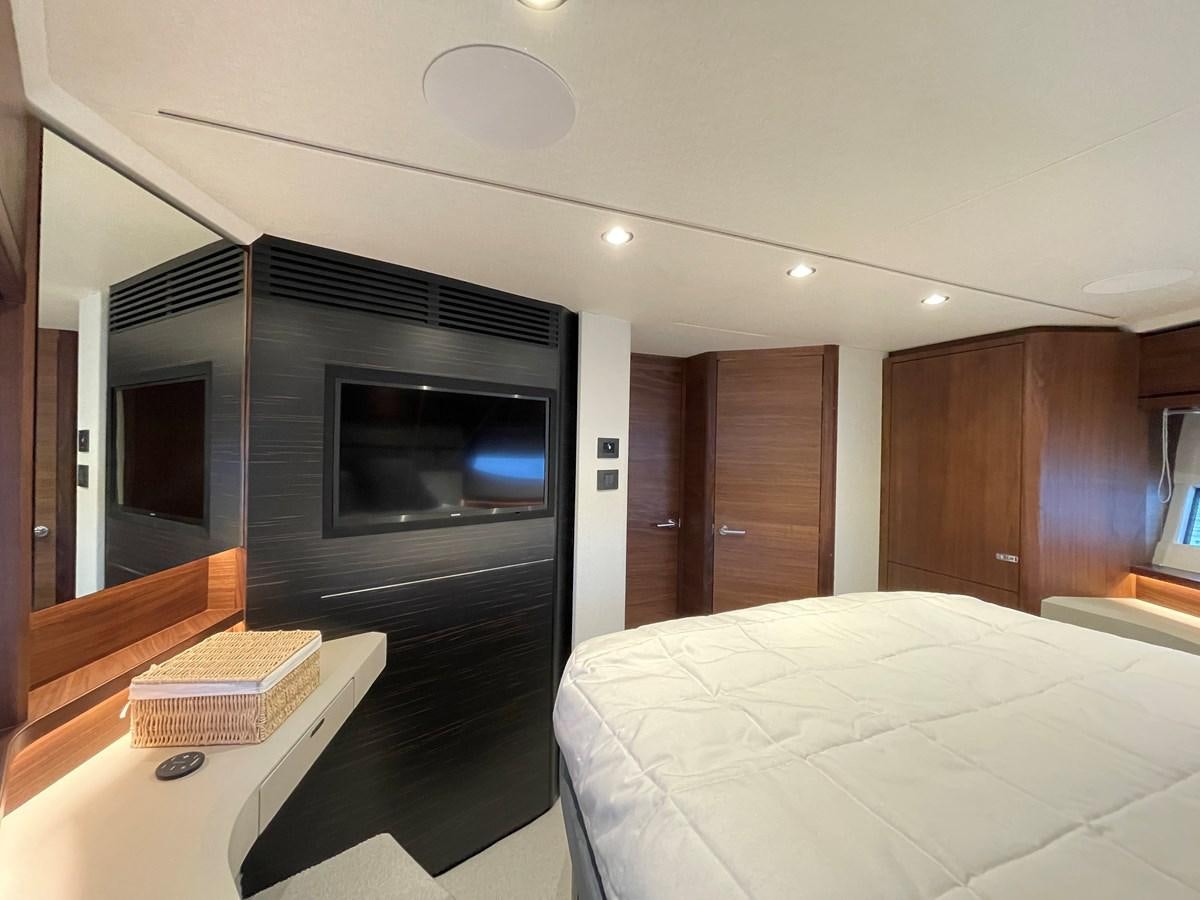 a bedroom with a bed and a television aboard LESTO Yacht for Sale