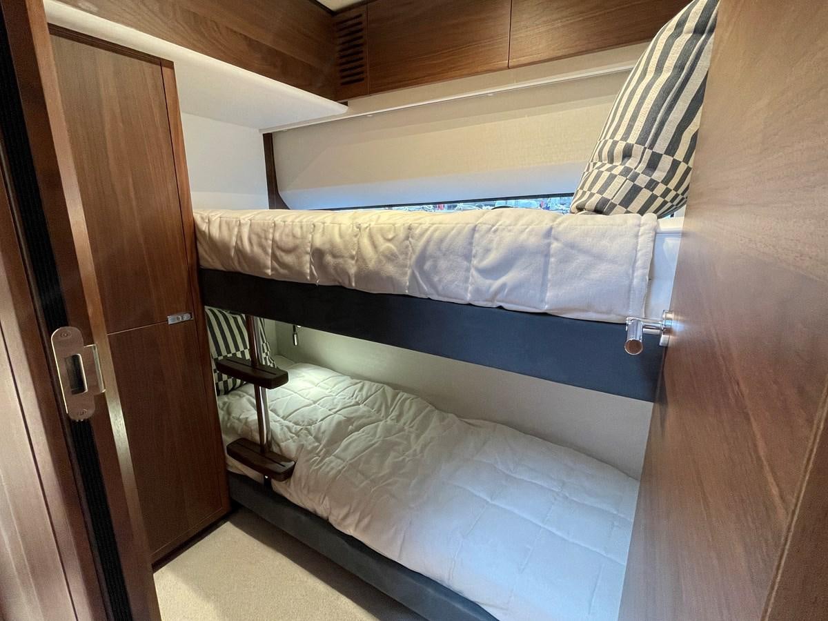 a bed with a blue sheet aboard LESTO Yacht for Sale