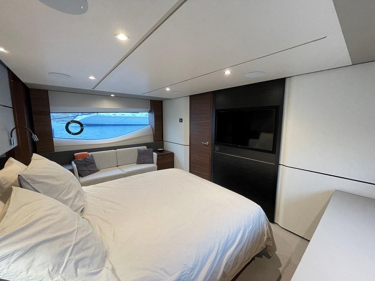 a bedroom with a large television aboard LESTO Yacht for Sale