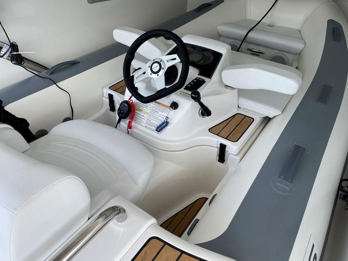 a white car with a steering wheel aboard LESTO Yacht for Sale
