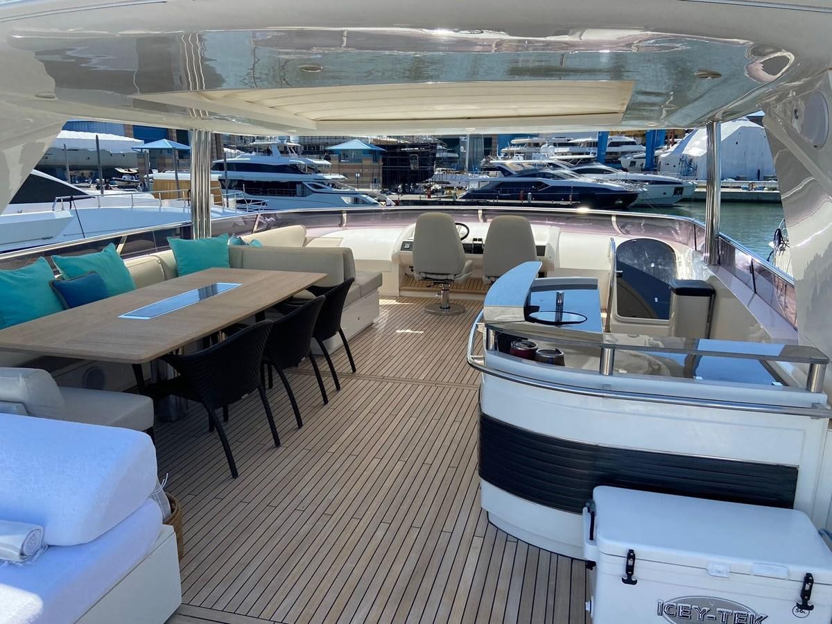 a room with tables and chairs aboard EXPERIENCE Yacht for Sale