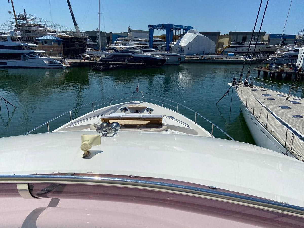 a large white boat in a harbor aboard EXPERIENCE Yacht for Sale