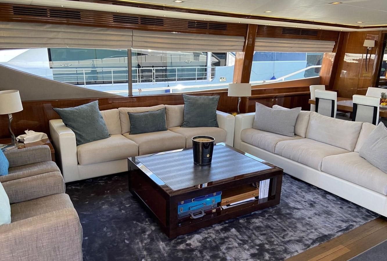 a living room with a couch and a coffee table aboard EXPERIENCE Yacht for Sale
