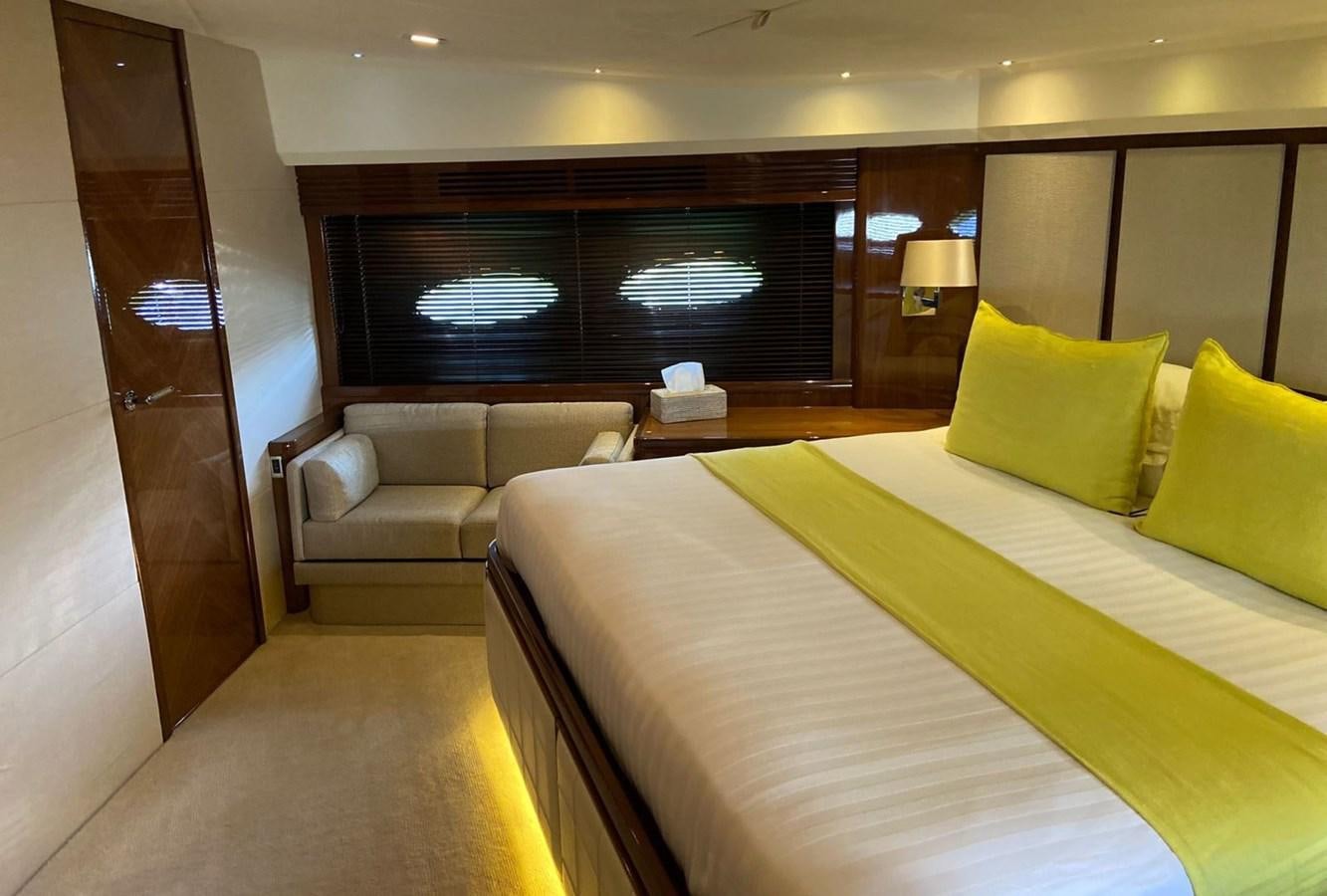 a hotel room with a bed and a couch aboard EXPERIENCE Yacht for Sale