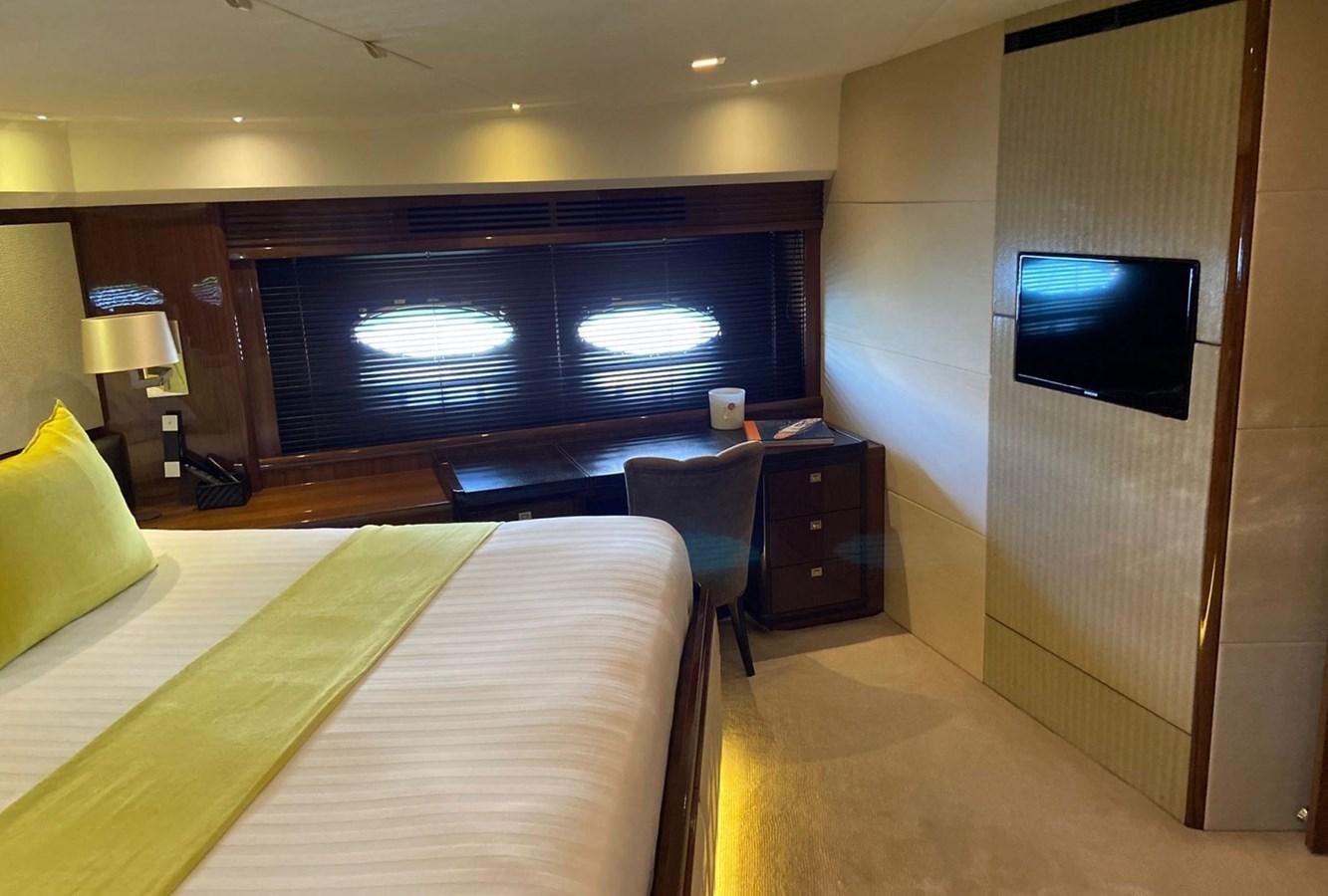 a hotel room with a tv and a bed aboard EXPERIENCE Yacht for Sale