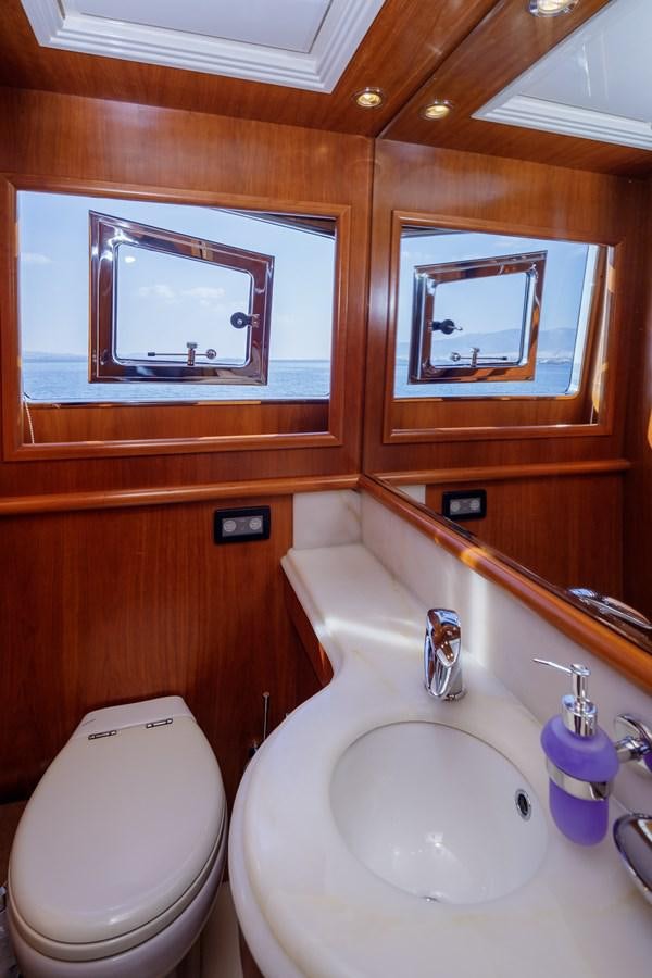 a bathroom with a mirror and a sink aboard SALTY Yacht for Sale