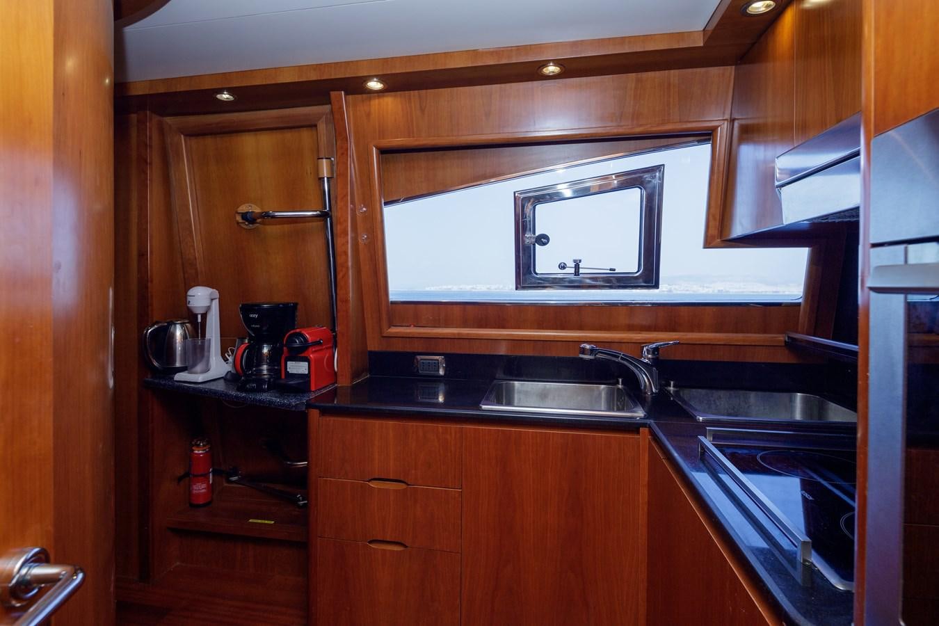 a kitchen with wooden cabinets aboard SALTY Yacht for Sale