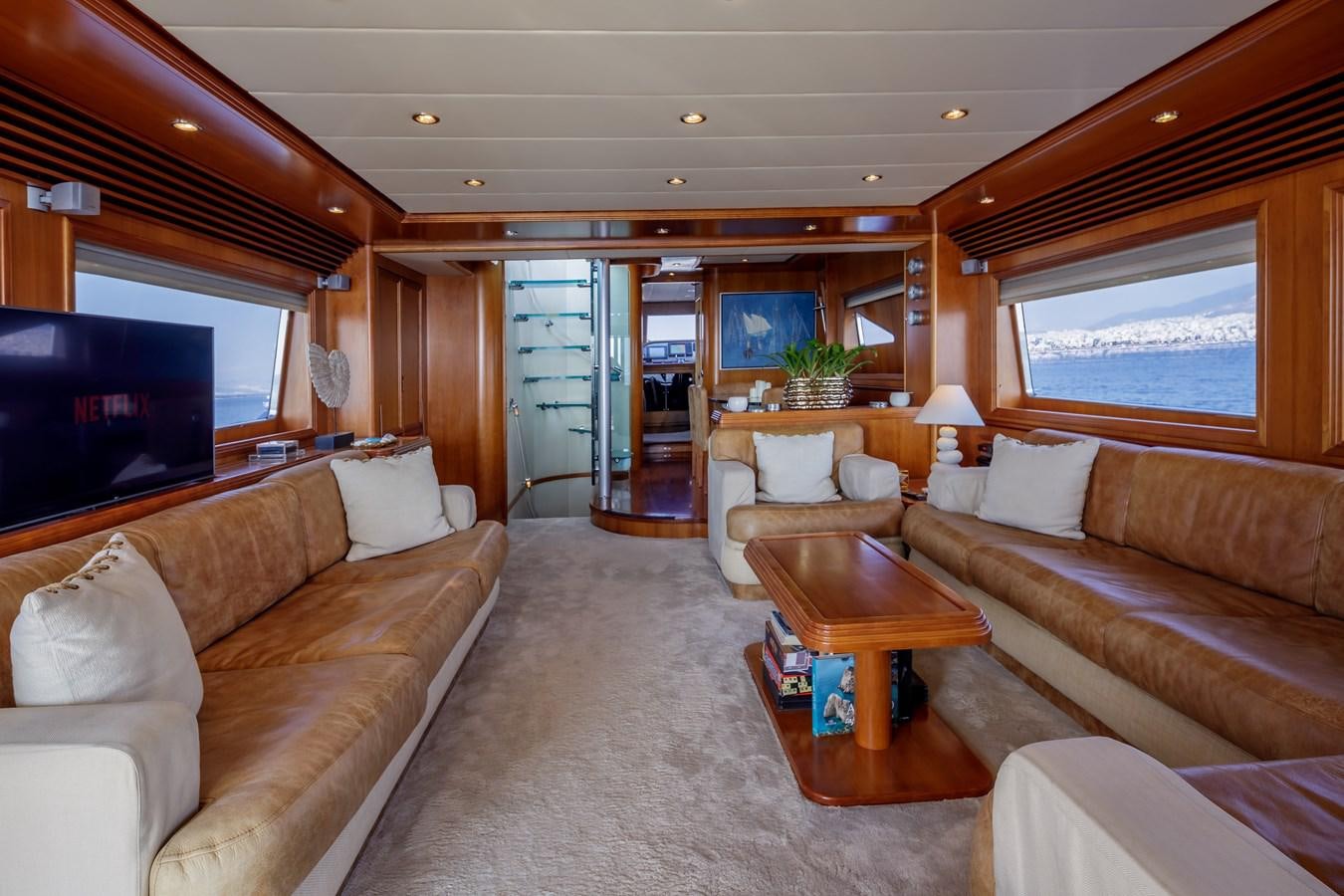 a living room with a couch and a tv aboard SALTY Yacht for Sale